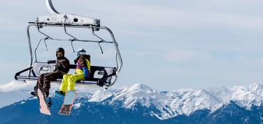 snowboarders on chair lift